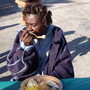 Helping those is the greatest of need. Woman eating.